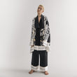 Load image into Gallery viewer, A model showcasing a stunning World Tree satin pajama set in black and white by Morgan & Tina.
