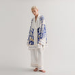 Load image into Gallery viewer, A model showcasing a stunning World Tree silk pajama set in blue and white by Morgan & Tina.