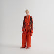 Load image into Gallery viewer, A model showcasing a stunning World Tree satin pajama set in red and black by Morgan & Tina.