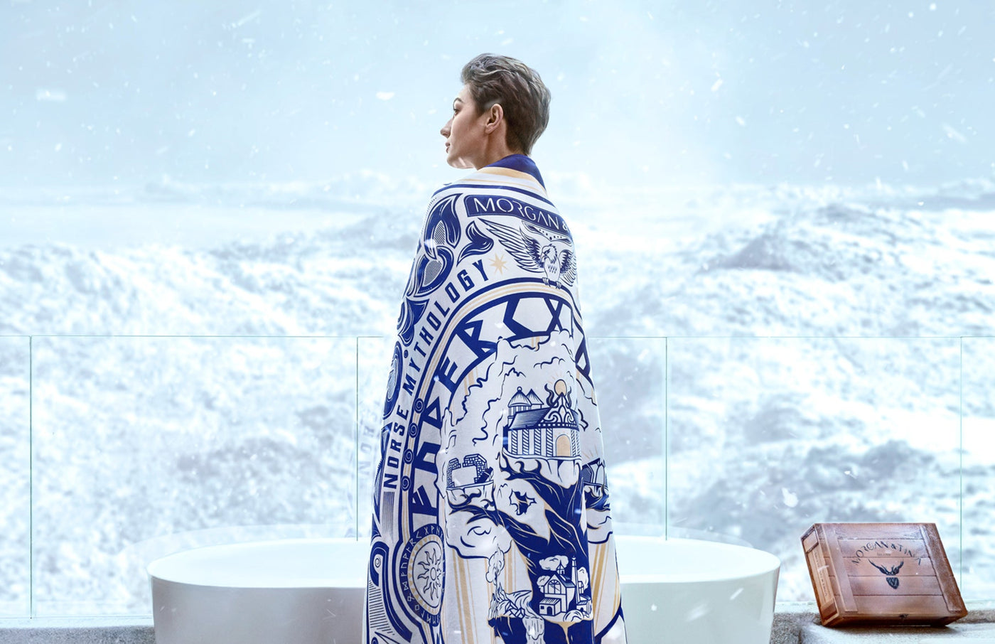 A woman wears the Morgan & Tina WORLD TREE design bath towel