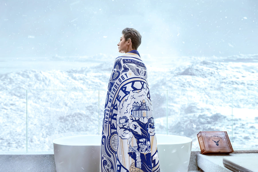 A woman wears the Morgan & Tina WORLD TREE design bath towel