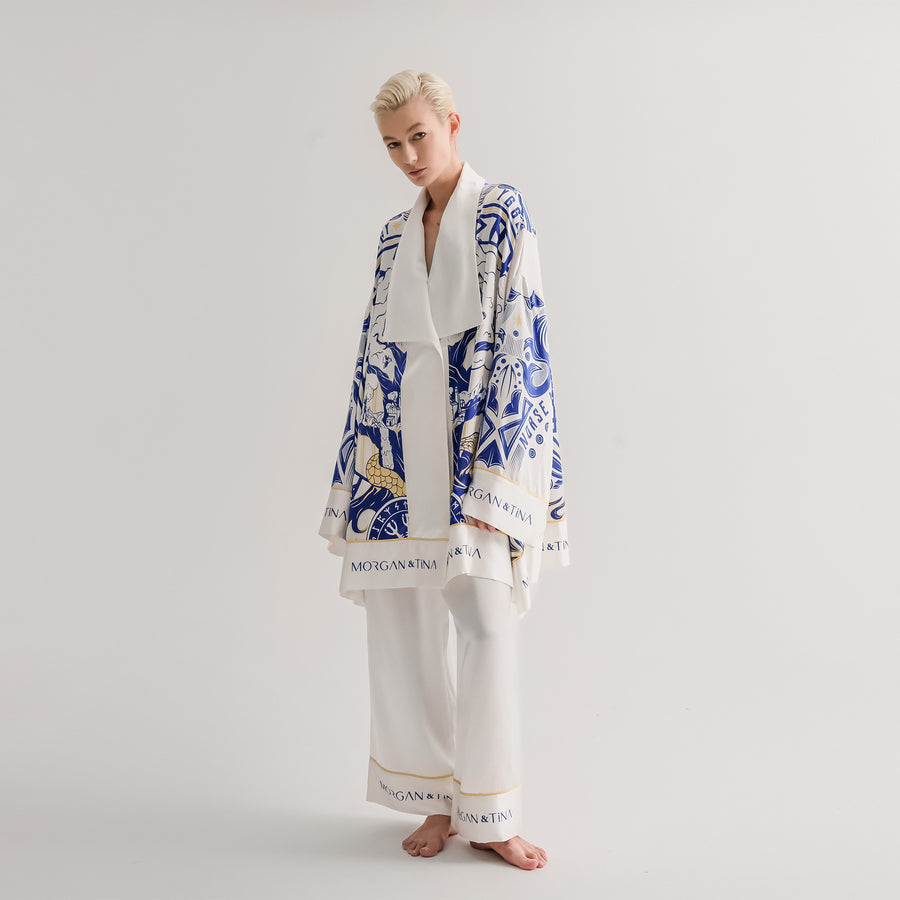 A model showcasing a stunning World Tree silk pajama set in blue and white by Morgan & Tina.